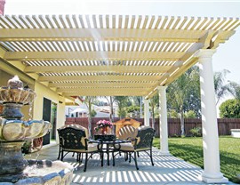 cream-colored patio cover with black chairs