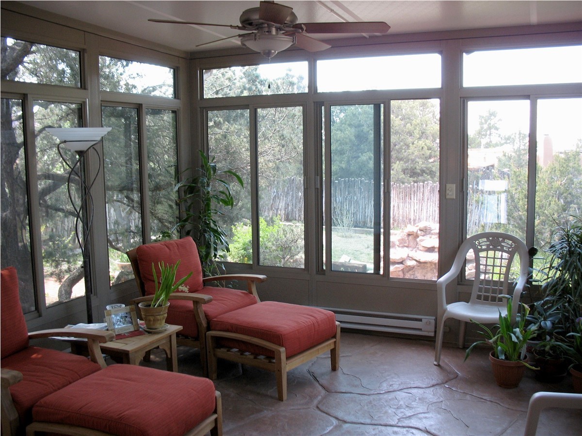 interior of sunroom with red chairs