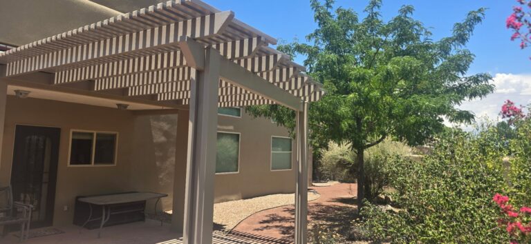 Lattice patio cover beside a stucco home