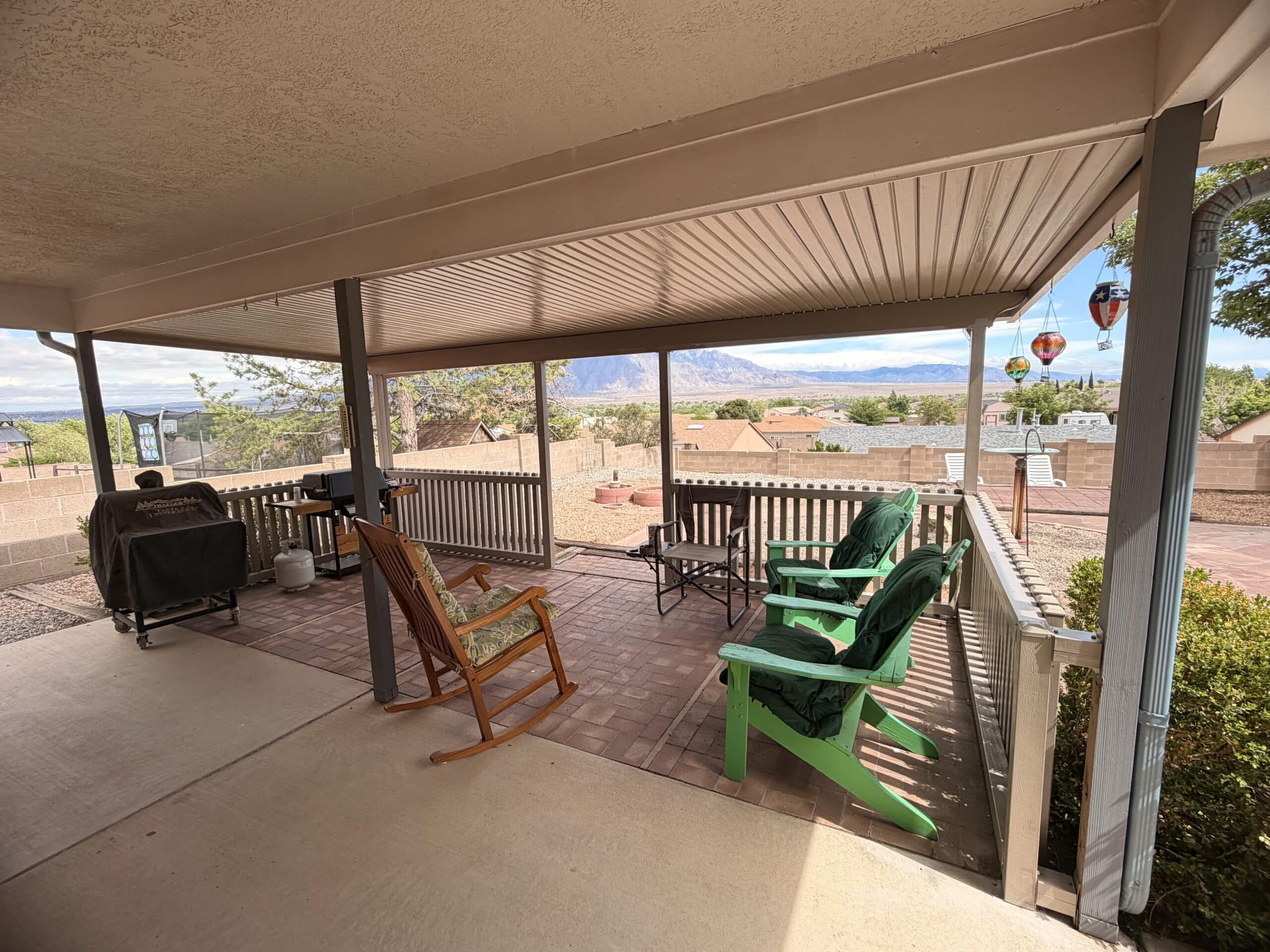 Covered patio with outdoor seating and railings
