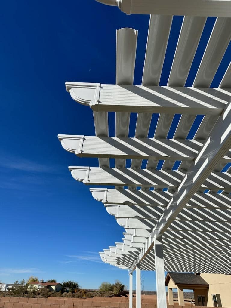 Close-up of operable pergola slats against a blue sky
