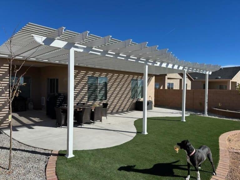 Operable pergola beside a home and lawn