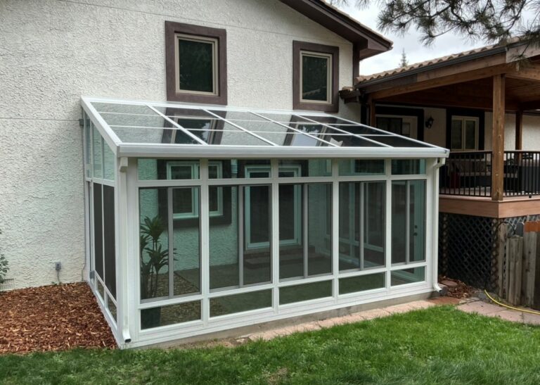 Studio solarium addition with a sloped glass roof