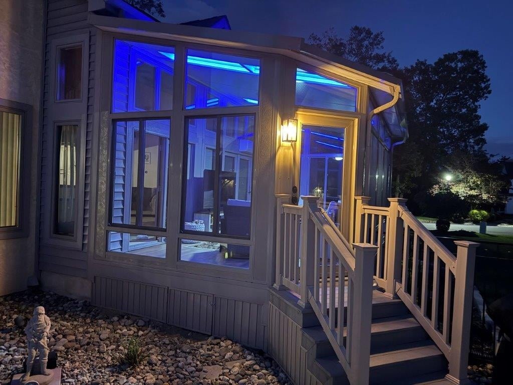 Sunroom with illuminated Skyview roof at dusk