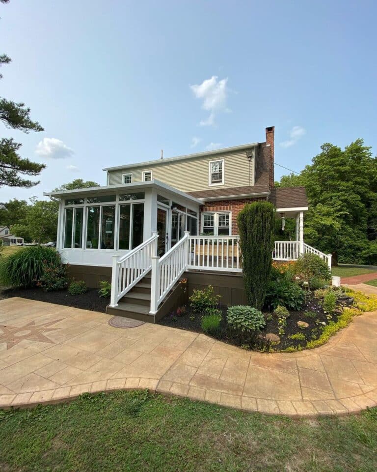 Studio sunroom and raised deck overlooking a yard