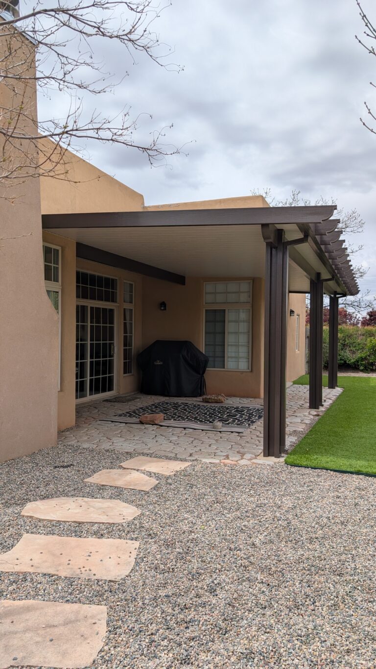 Shaded patio walkway beneath a solid patio cover