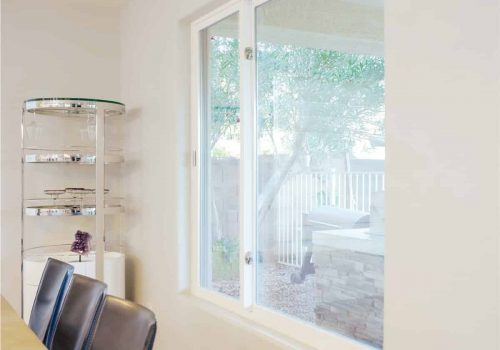 Glider window in a dining room overlooking an outdoor patio